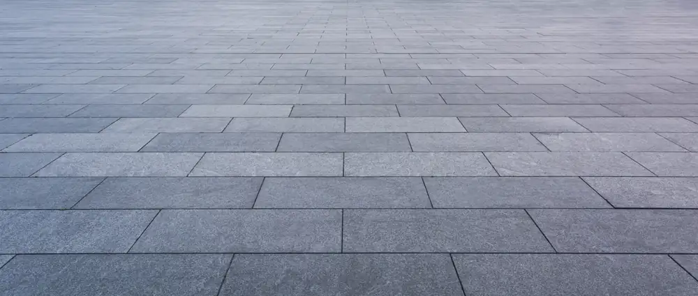 Close-up of grey block paving laid in a neat stretcher bond pattern