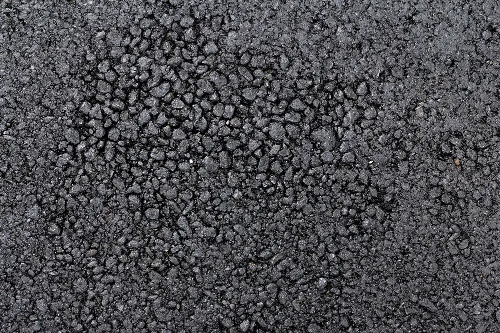 Close-up of a dark resin bound surface showing the natural aggregate